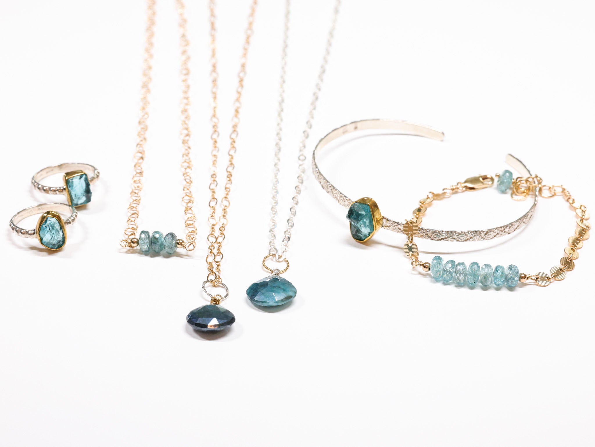 Handcrafted Apatite jewelry set with deep blue-green gemstones in rings, necklaces, cuff bracelet, and beaded bracelet