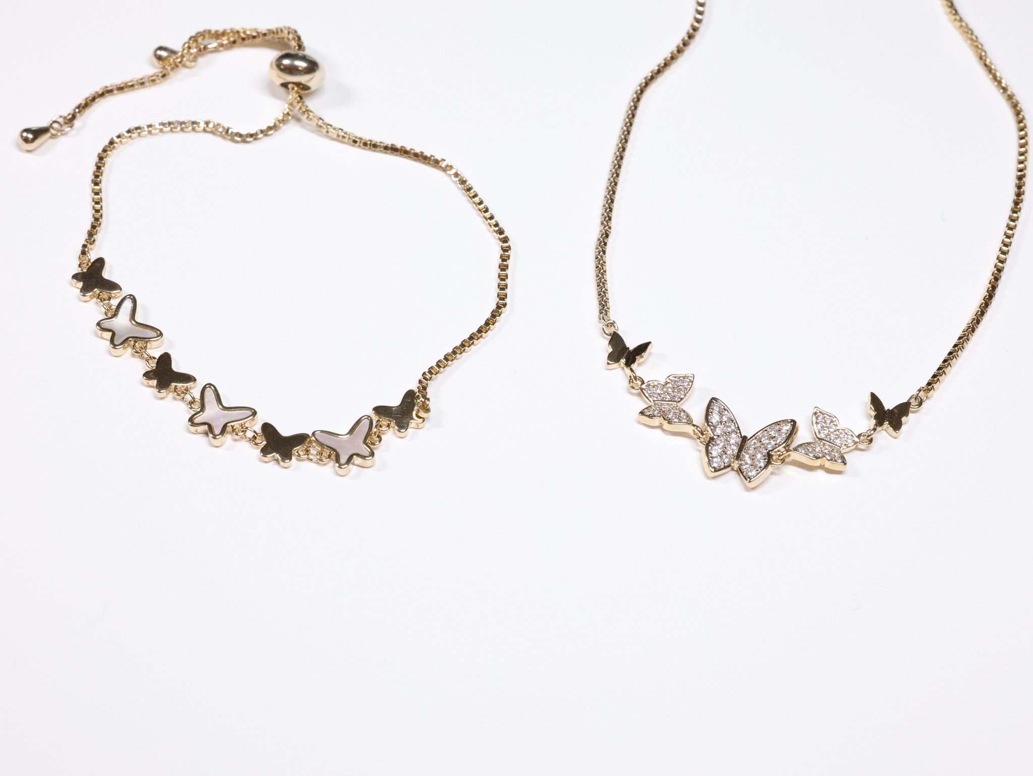 Gold butterfly chain bracelets and necklaces with mother of pearl and crystal details from Ardor Boutique