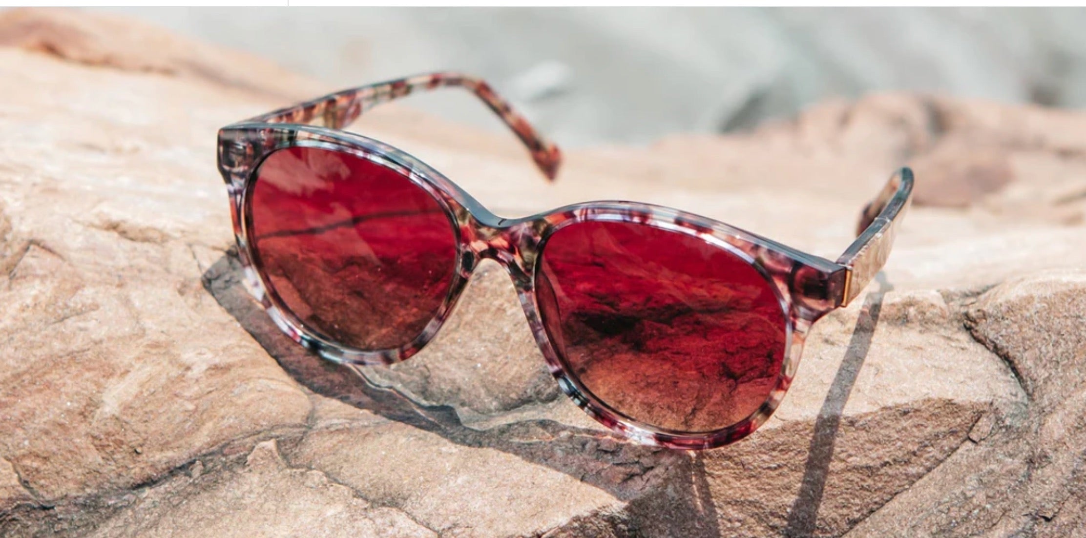 Tortoise sunglasses with round red polarized lenses.