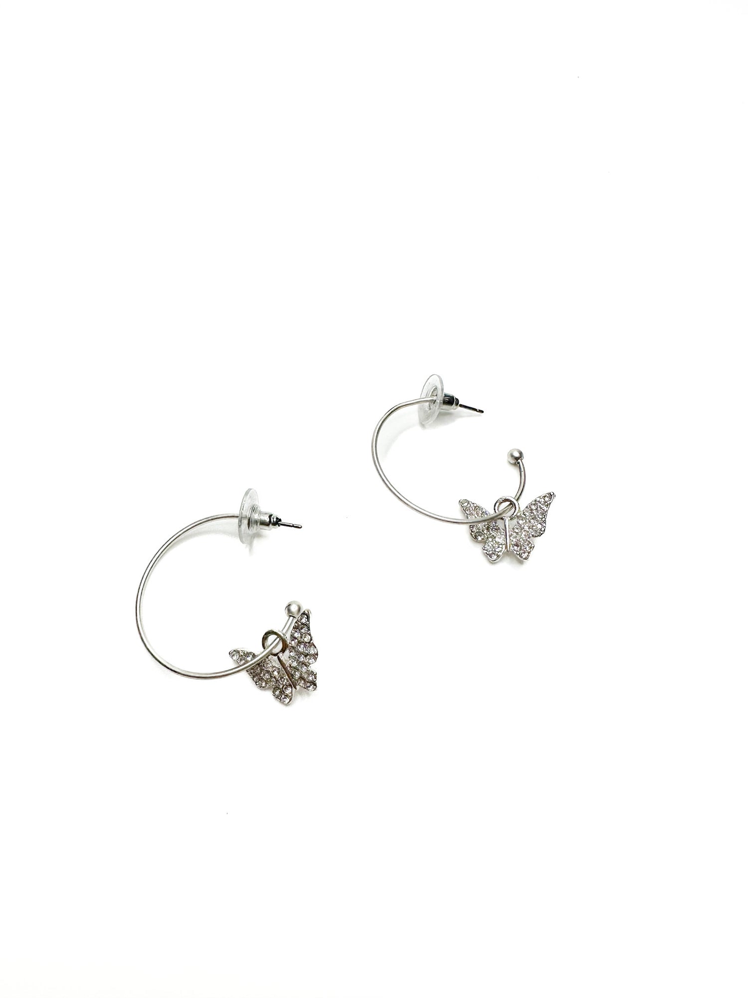 Silver butterfly earrings on a white background