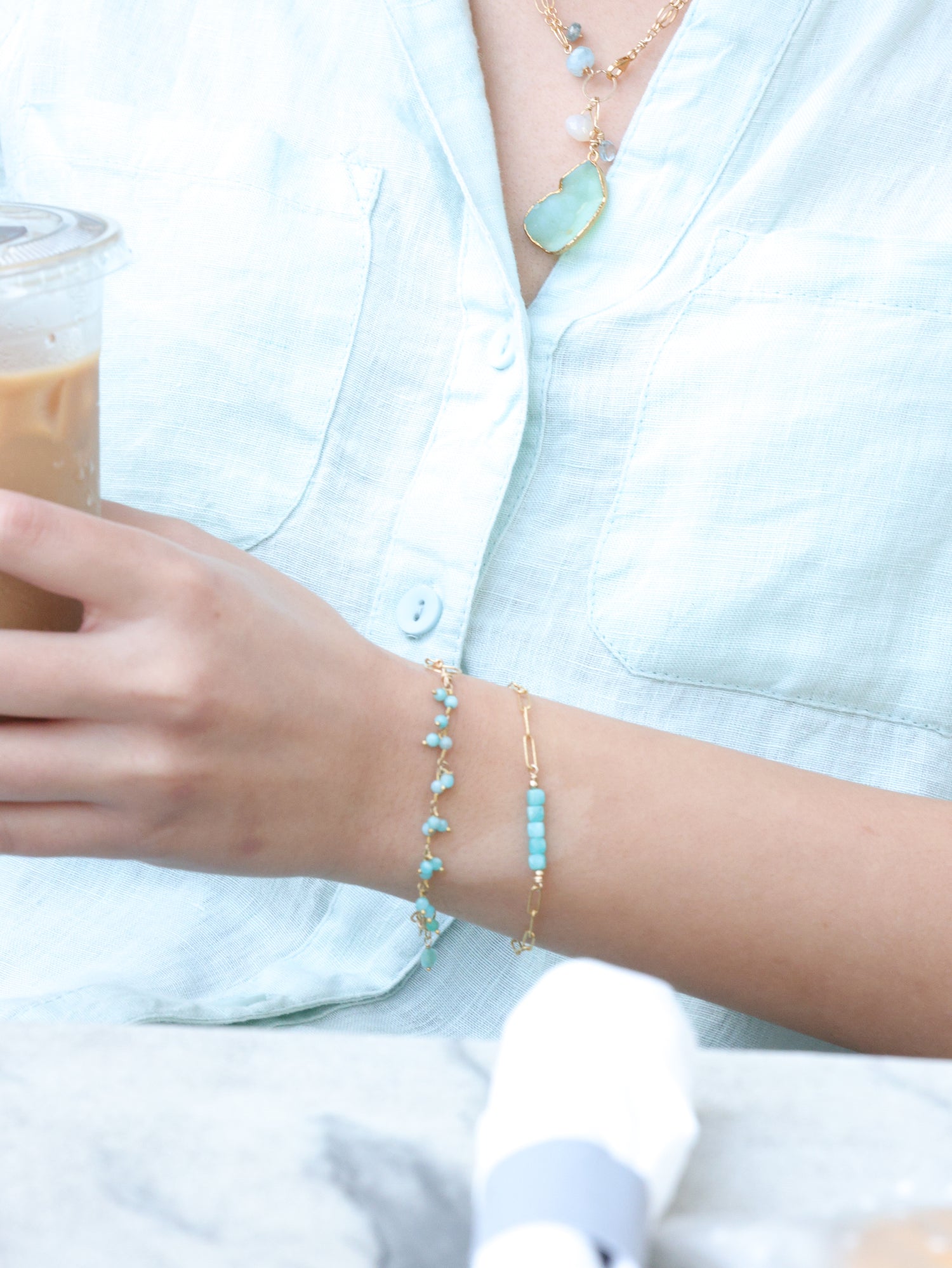 close up of amazonite tiny stone bracelets layered on model