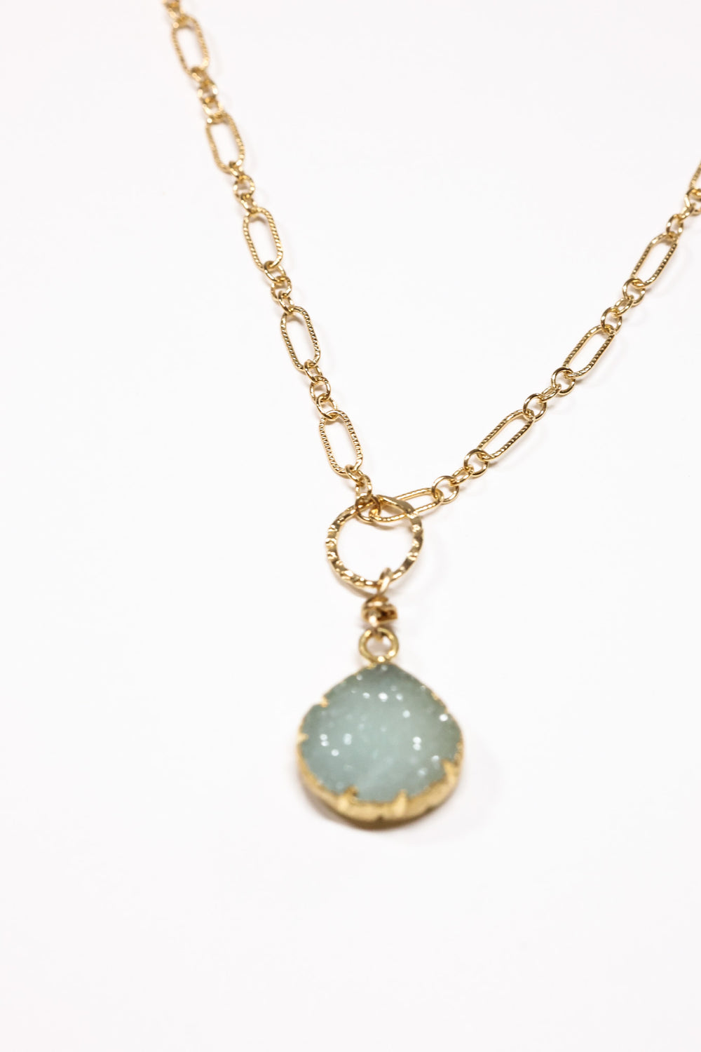 simple small Aqua druzy necklace up close of pendant, on flat lay 