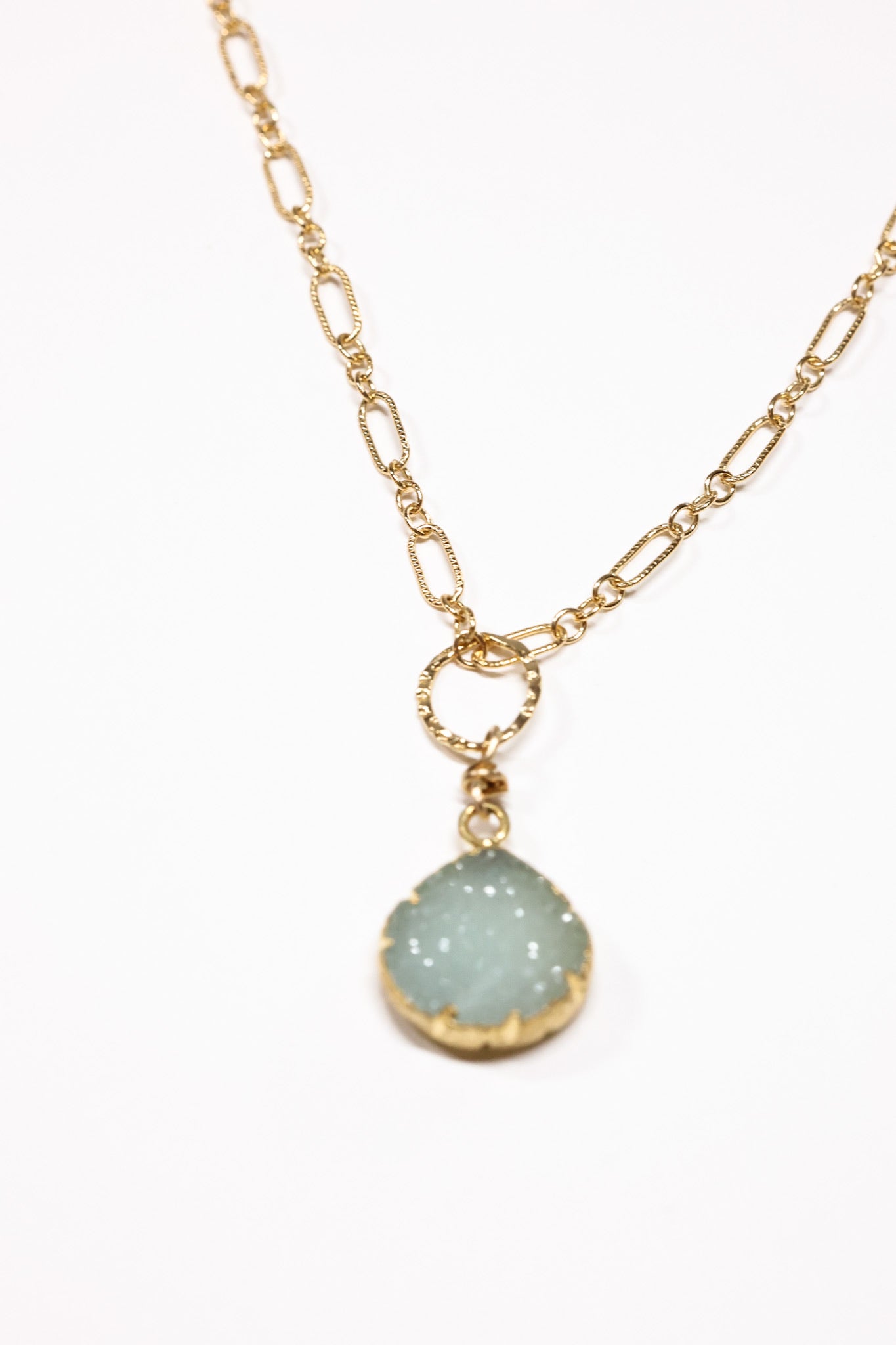 simple small Aqua druzy necklace up close of pendant, on flat lay