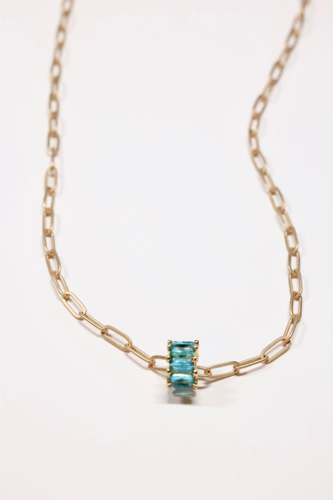 Aqua Crystal rondel necklace in gold on flat lay