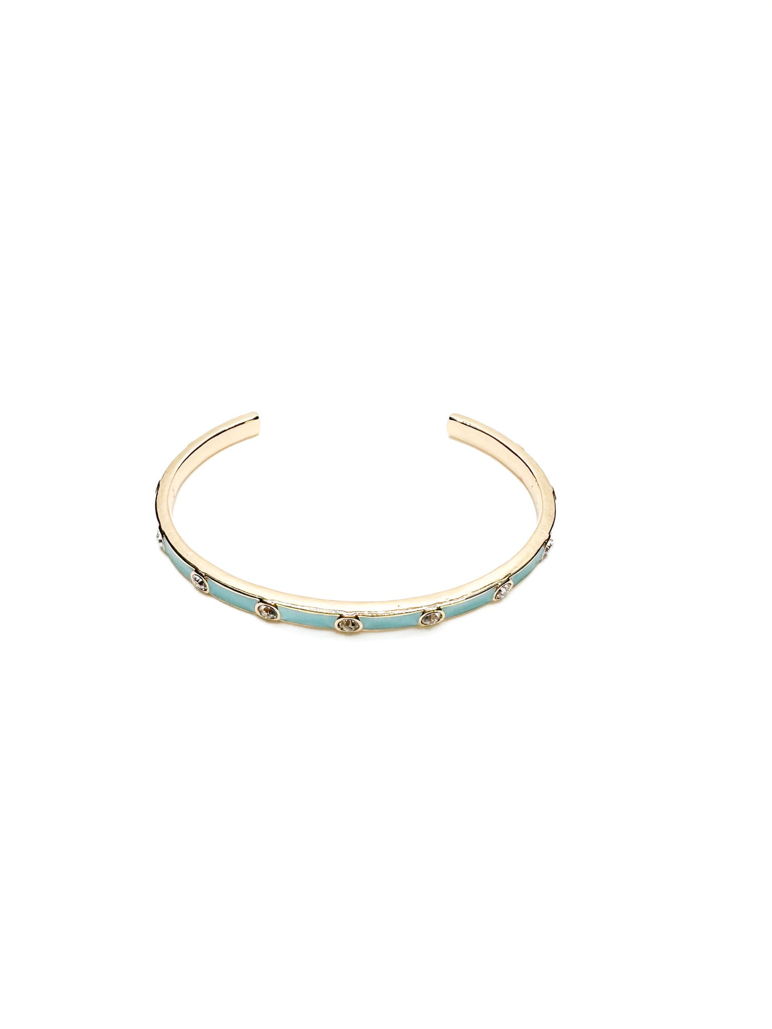 Gold bracelet with turquoise band and sparkle accents on a white background