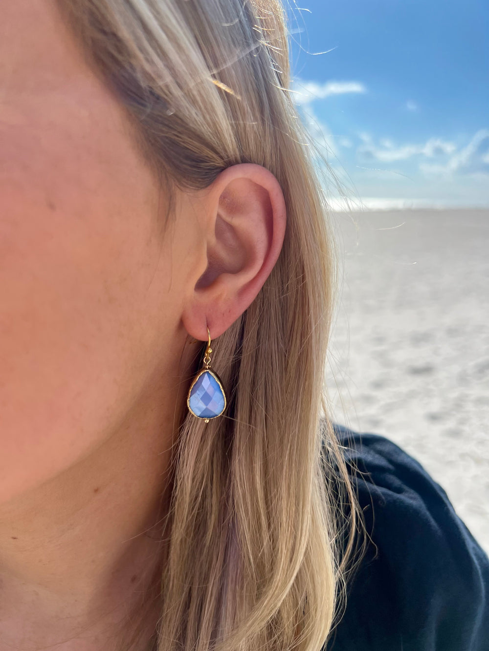 Blue and gold nickel free tear drop shaped earrings in ear