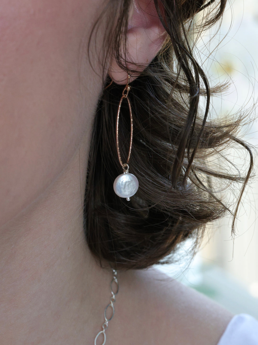 white pearl earrings on a woman