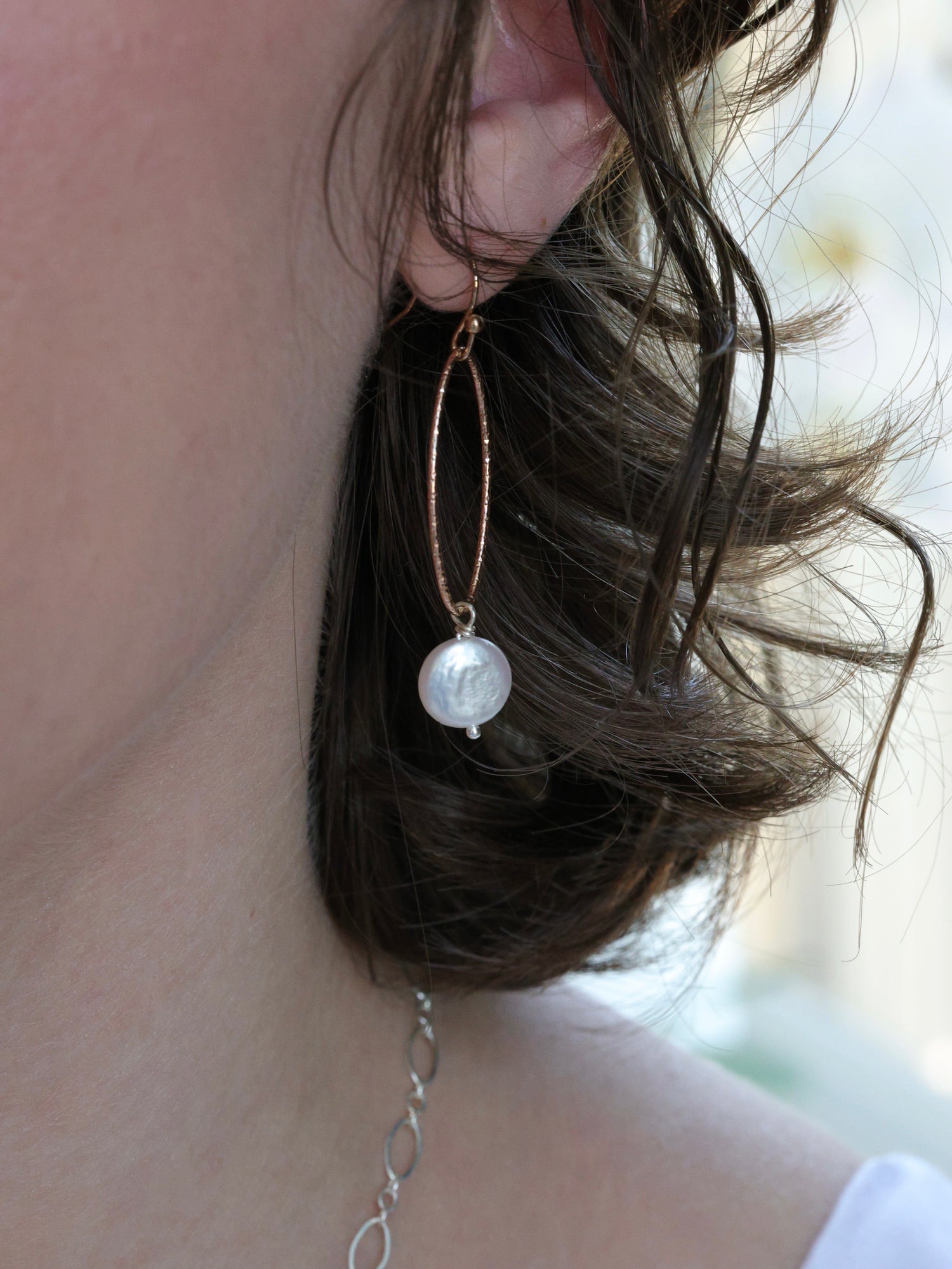 white pearl earrings on a woman