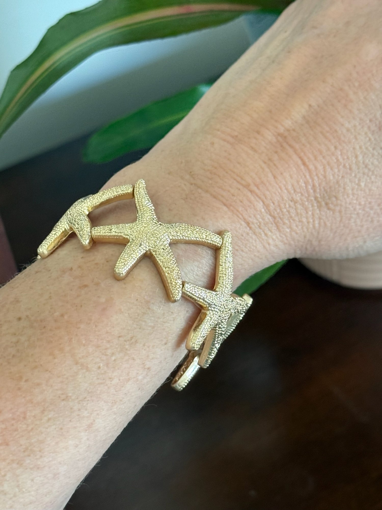 Large gold starfish stretch bracelet on model