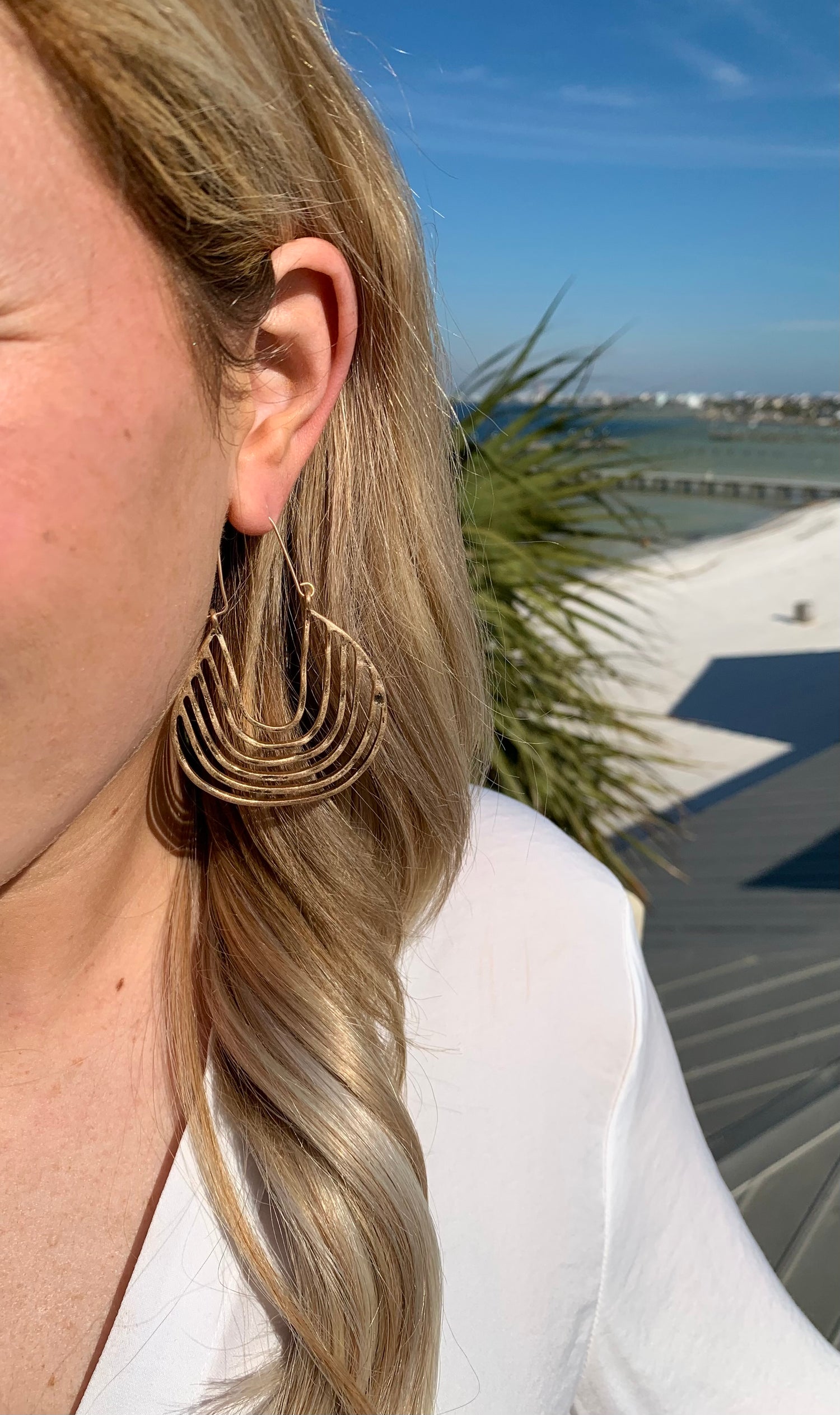 Gold drop hoop Mikayla earrings in ear for size reference