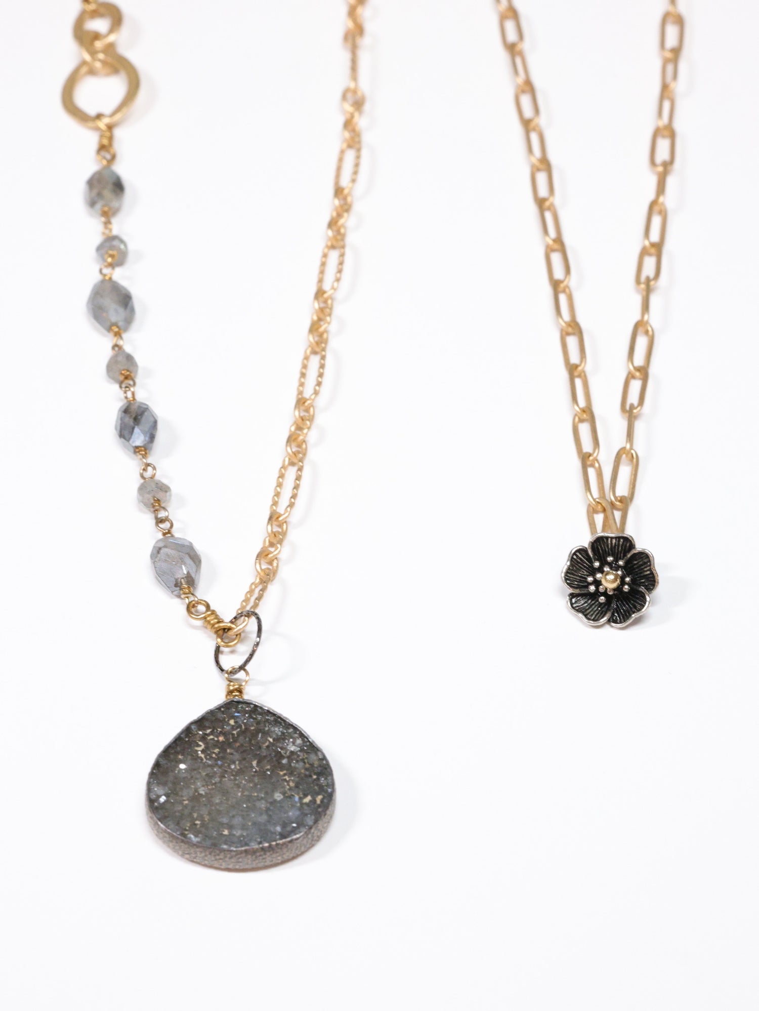 Two necklaces with different pendants on a white background