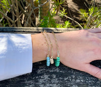 Pennie beaded bracelet/gold. Triple beaded chain bracelet with gold accent. Chain side on model. 