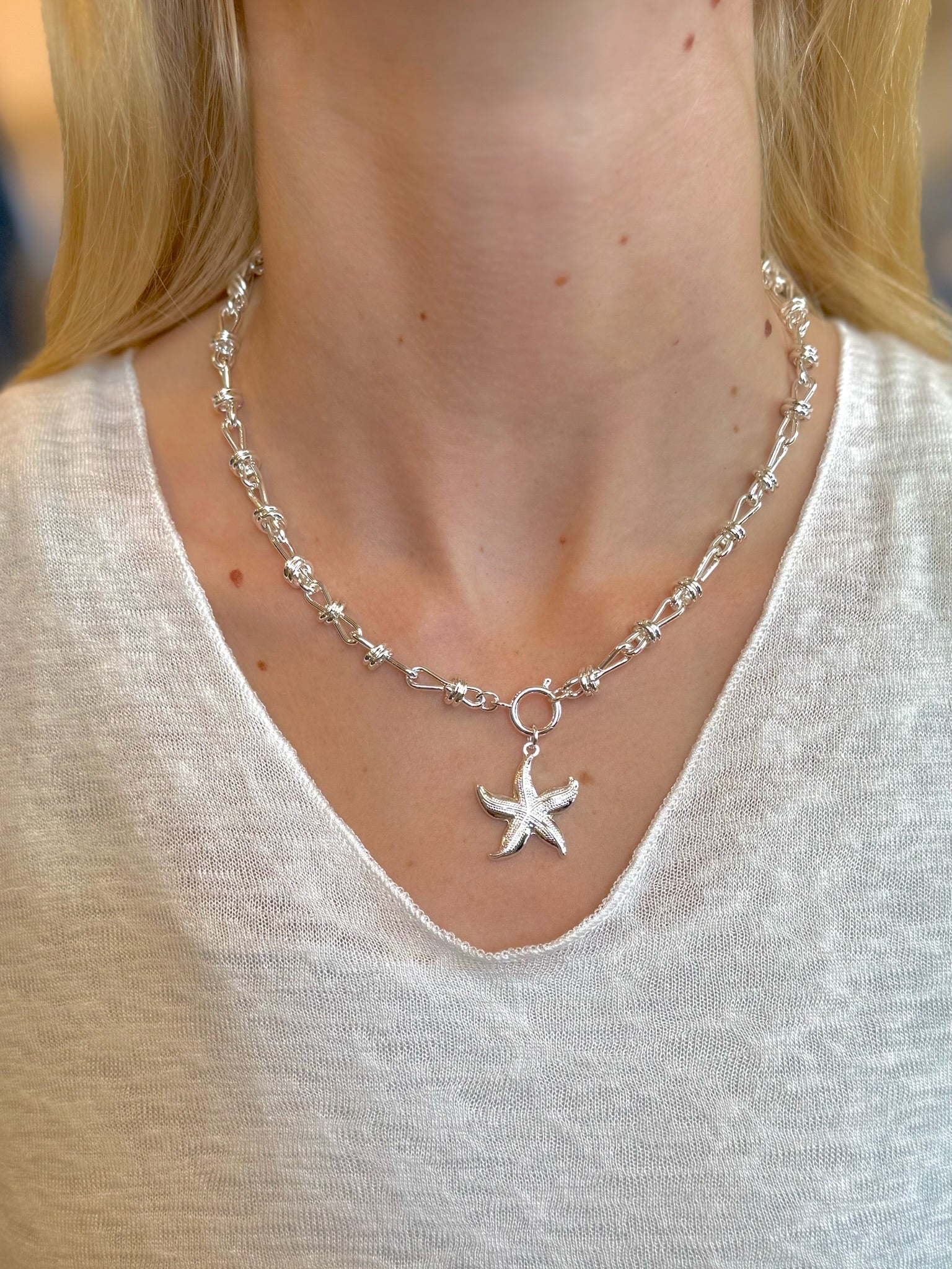 Lola Starfish Necklace in silver with textured pendant on model neck