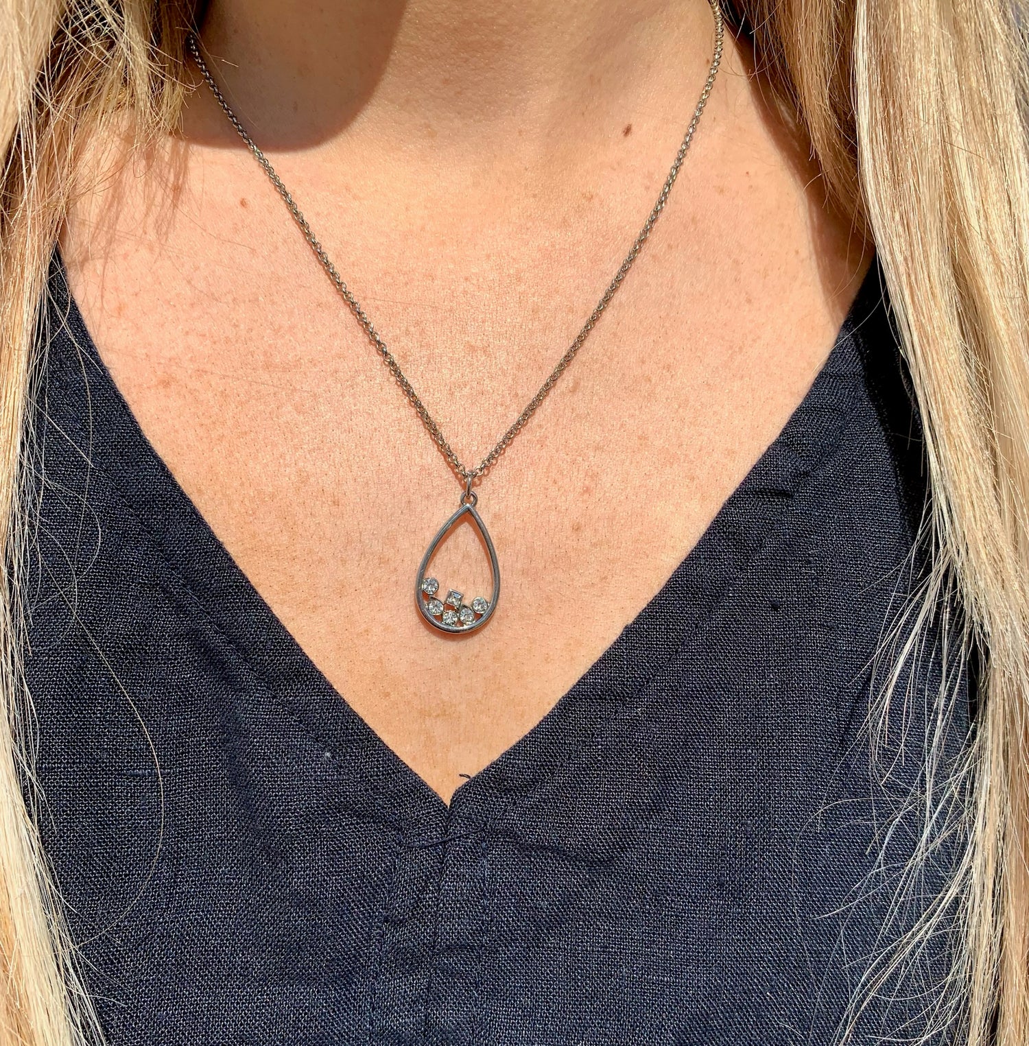 Rowan drop necklace silver on model.