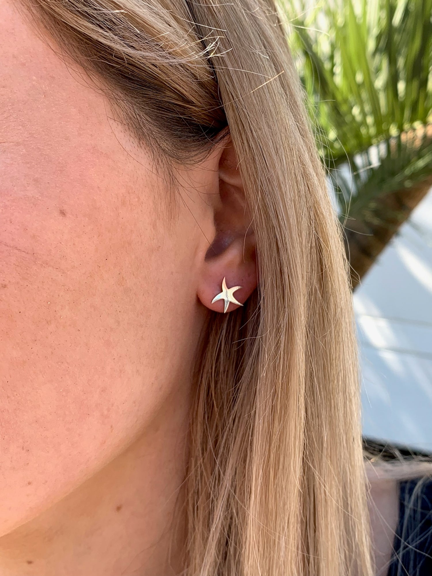 Alina large starfish studs on model.