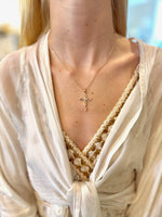 Gold Claire Cross Necklace with a delicate twisted cross pendant on a 19-inch chain.