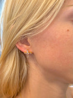 Grace Cross Studs in gold with baguette-style crystals on woman's ear
