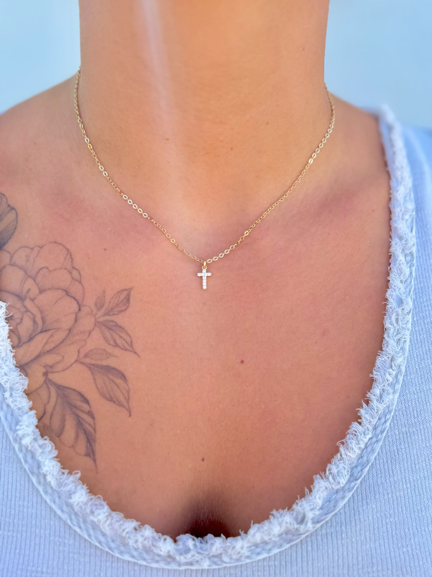 Adjustable 15–17.25 inch Amaris Gold Cross Necklace with gold-filled chain and sparkling cross charm being worn.