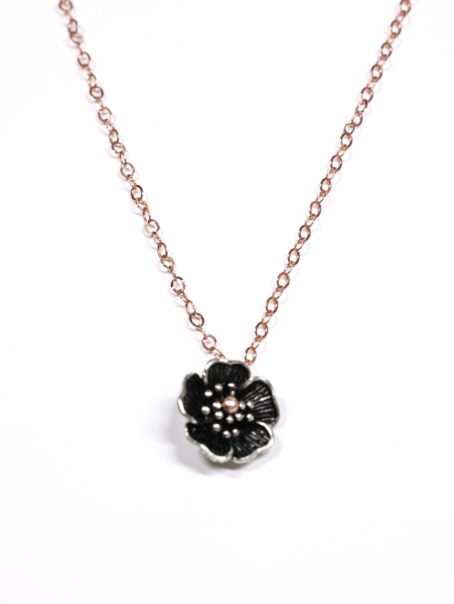 Close-up of a rose gold necklace with a five-petal flower pendant and dual-link chain – Five Fold Bloom Necklace in rose gold