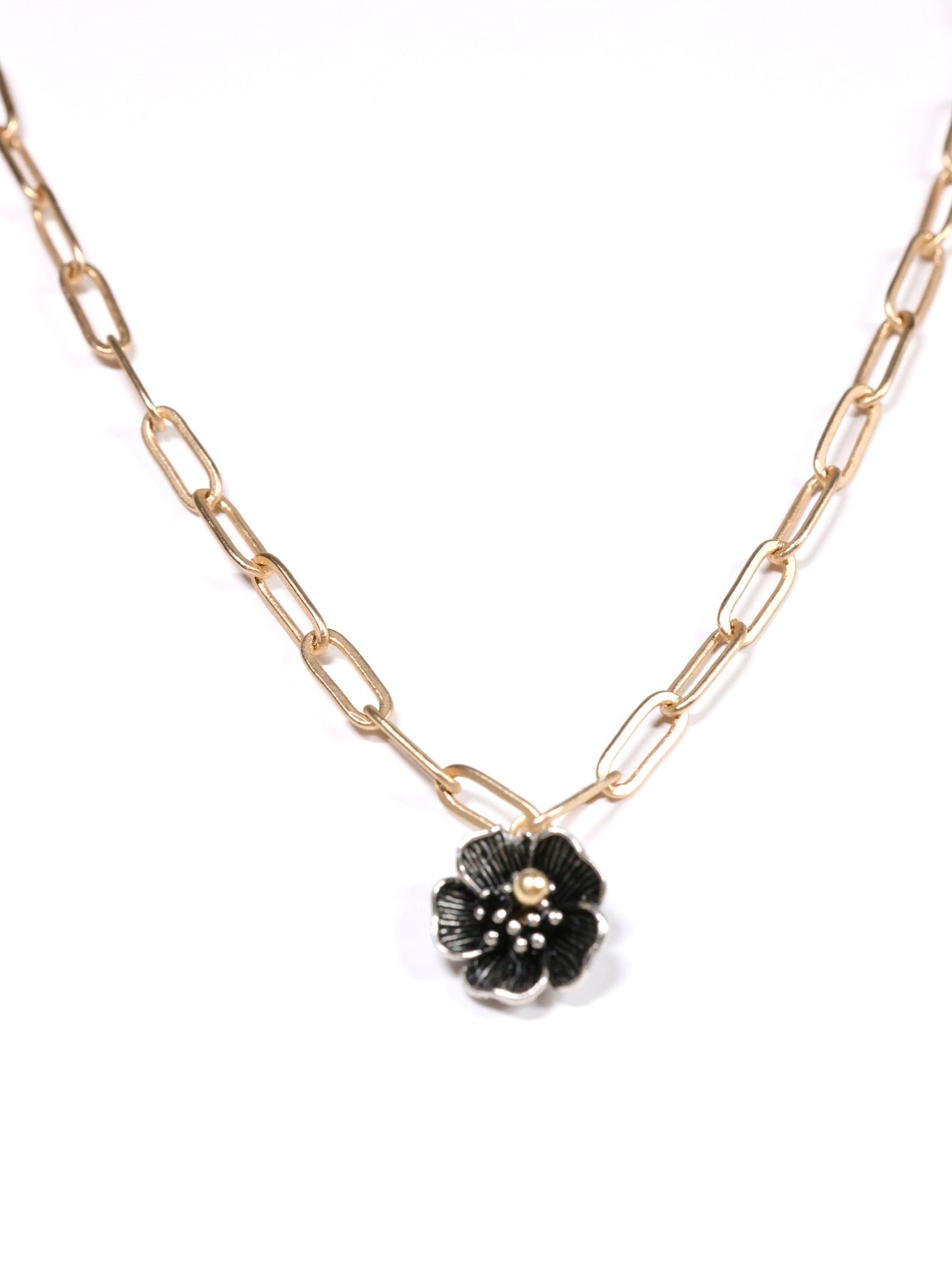 Close-up of a matte gold necklace with a five-petal flower pendant and dual-link chain – Five Fold Bloom Necklace in matte gold