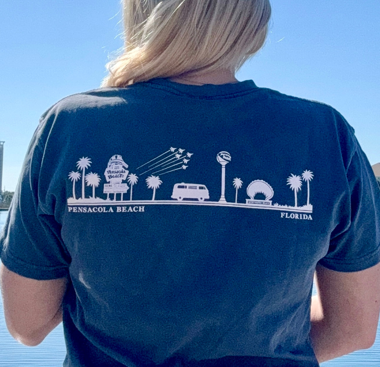 View of the back of the Pensacola Beach Icon Tee shown in navy on model