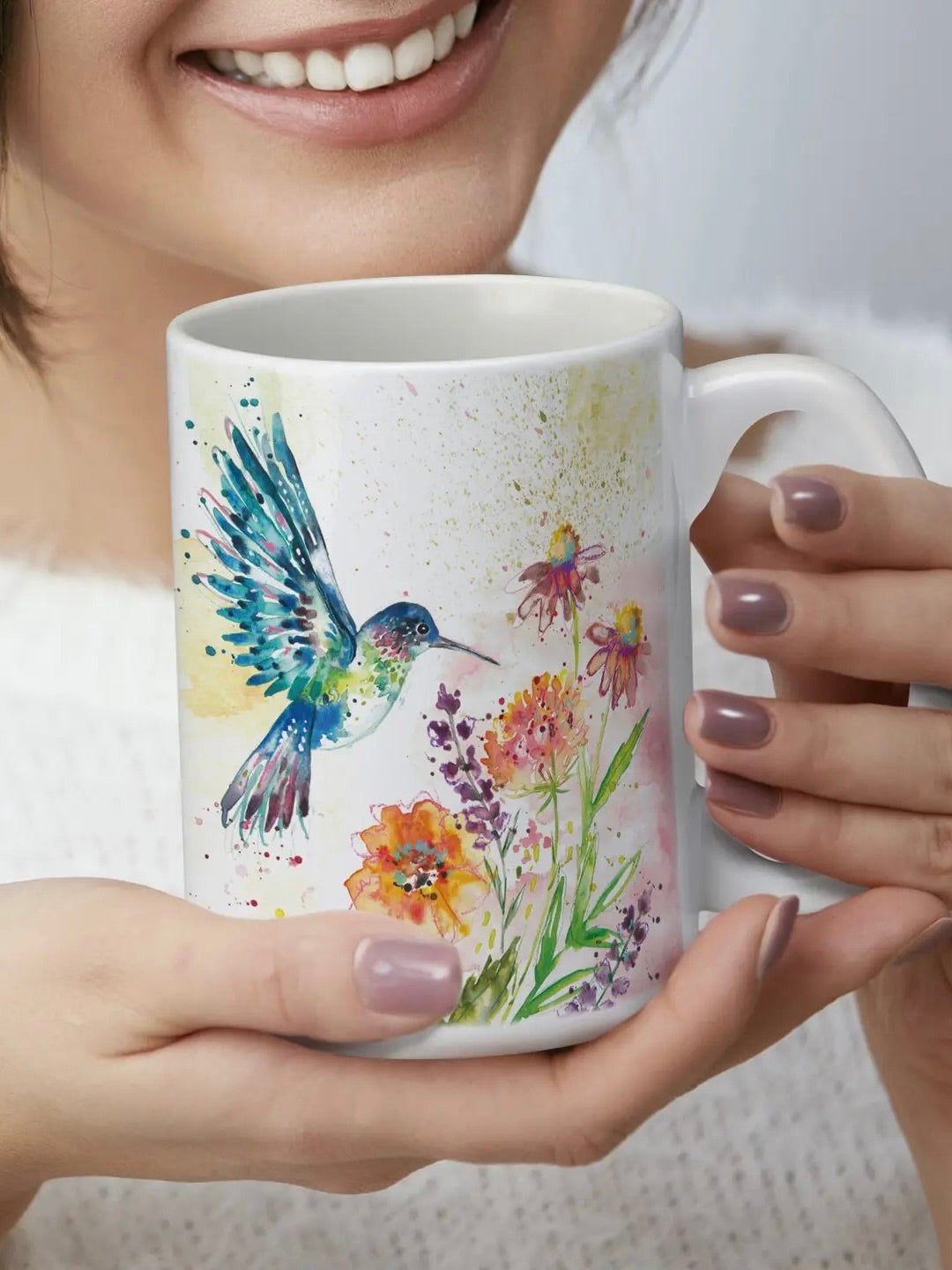 Watercolor hummingbird and floral mug held by woman