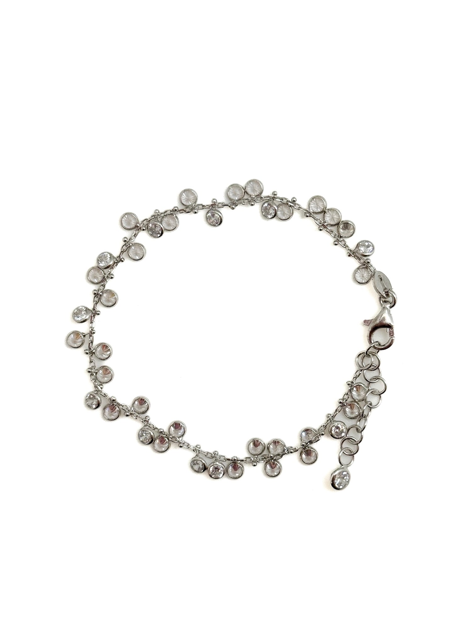 Silver bracelet with clear stones on a white background