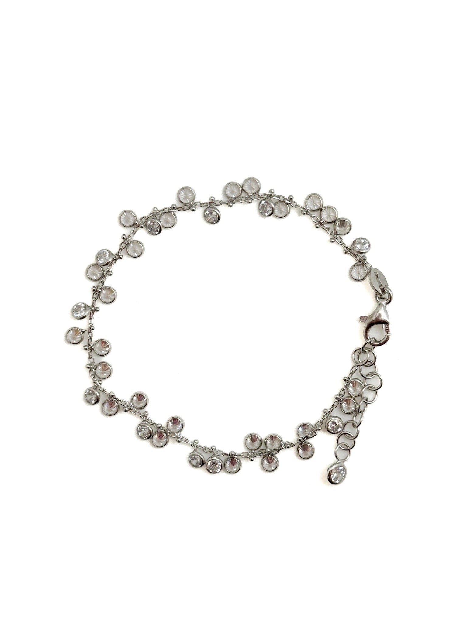 Silver bracelet with clear stones on a white background
