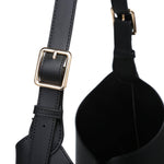 Black leather bag with gold buckle on a white background