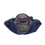 A navy blue nylon fanny pack shown open, displaying its gray interior lining, zippered compartments, and a black-and-white braided shoulder strap on a white background.