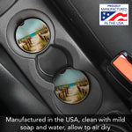 Car cup holder with scenic coast design coasters and 'Proudly Manufactured in the USA' badge.