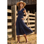 Navy maxi dress with a smocked bodice, V-neckline, ruffle short sleeves and a flowing tiered skirt at Ardor Boutique.
