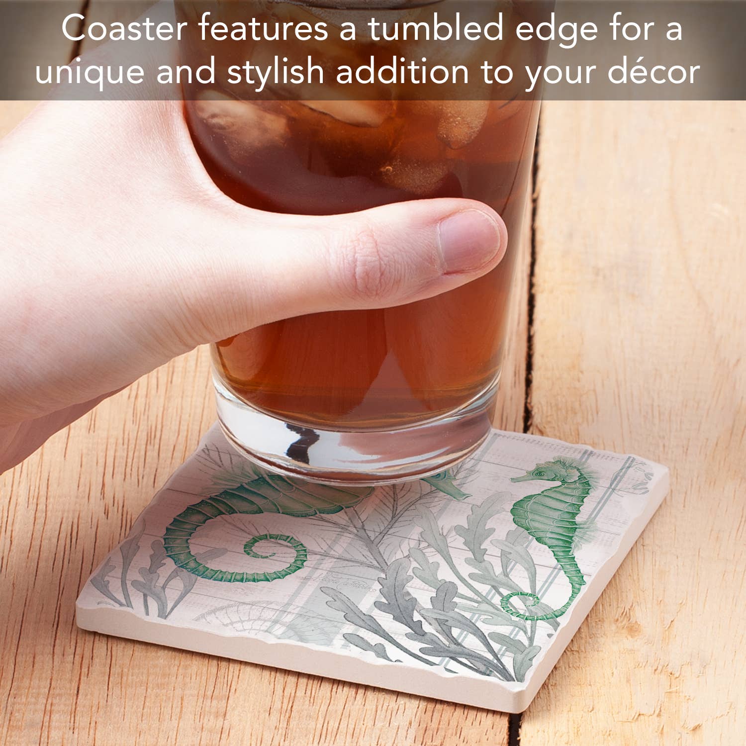 Coaster with seahorse design holding a glass of iced tea on a wooden surface