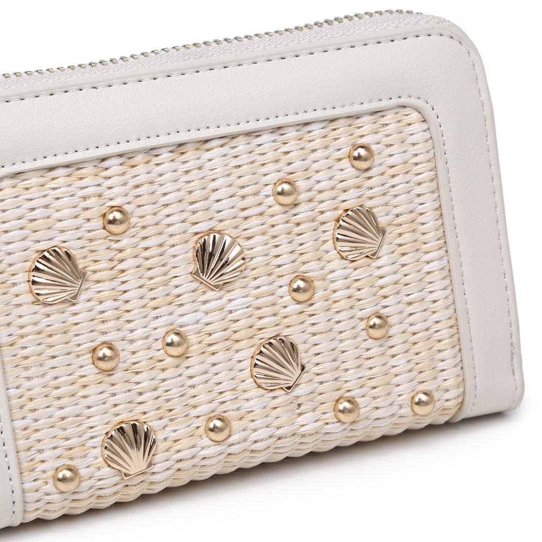 Close-up of a white handbag with shell and pearl embellishments on a white background
