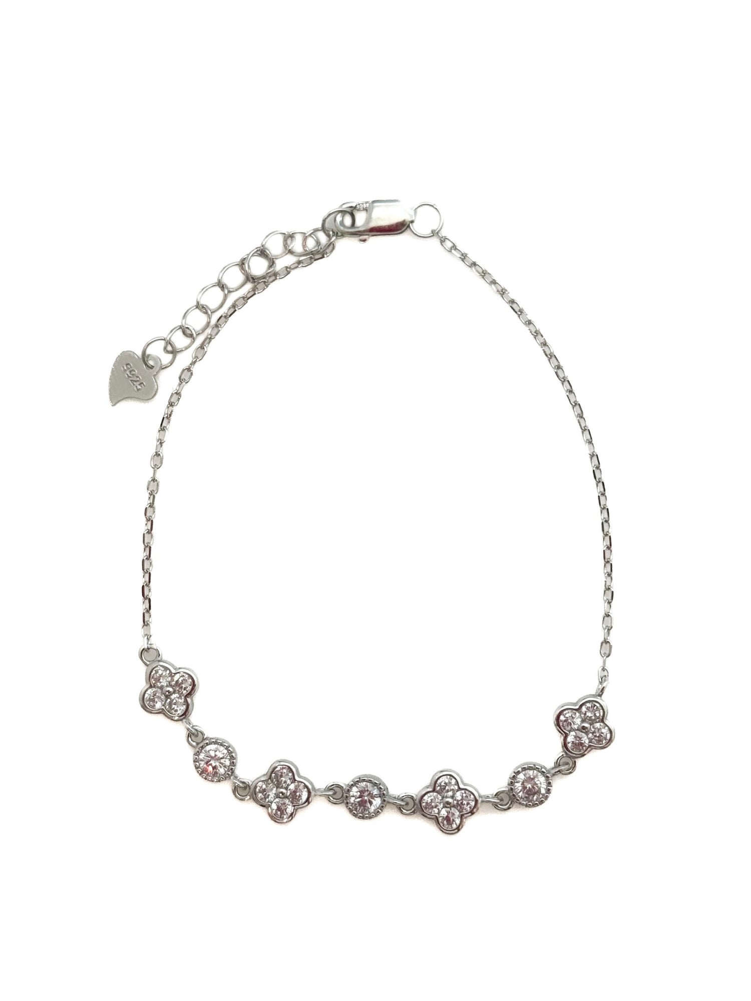 Silver bracelet with floral designs on a white background