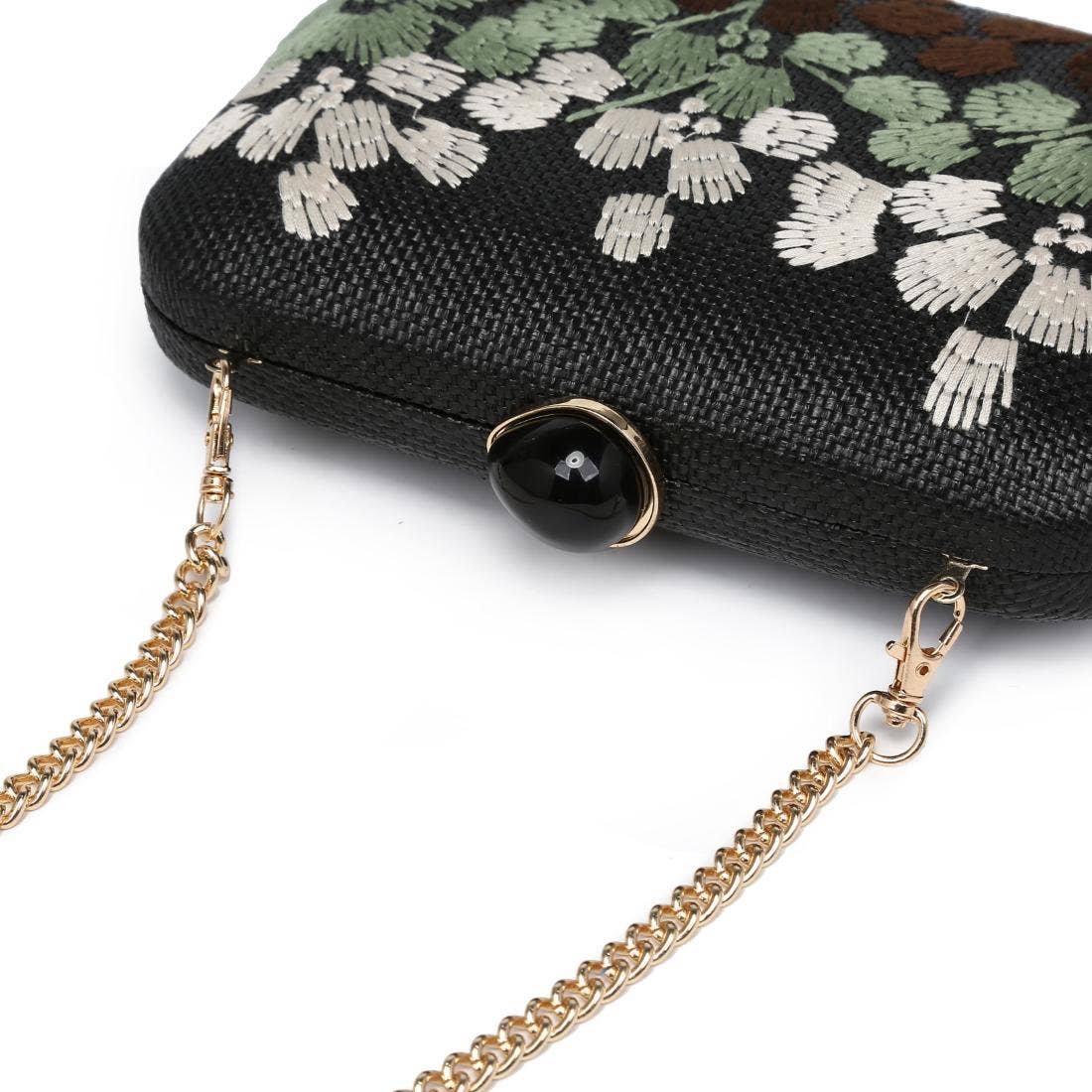 Black clutch with floral embroidery and gold chain strap on a white background