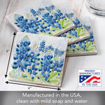Three square coasters with a blue and green floral print are arranged on a white wood surface. Black dimension arrows indicate a 4 by 4 inch size, and a badge reads 'Proudly Manufactured in the USA.