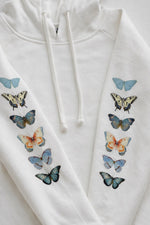White hoodie with colorful butterfly designs on a white background
