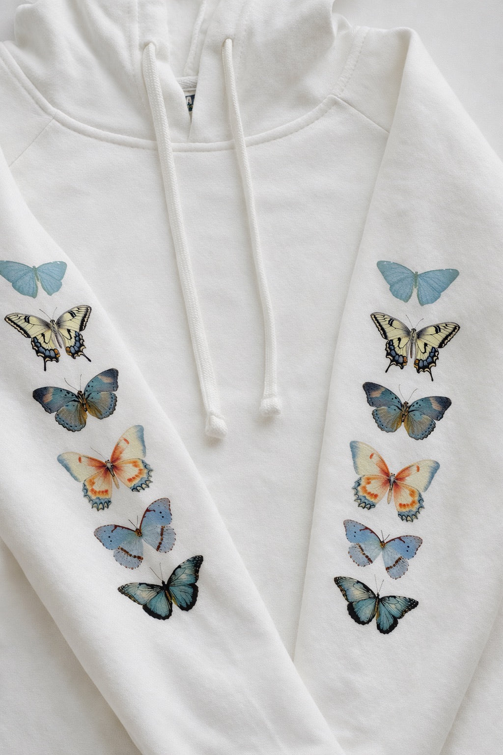 White hoodie with colorful butterfly designs on a white background