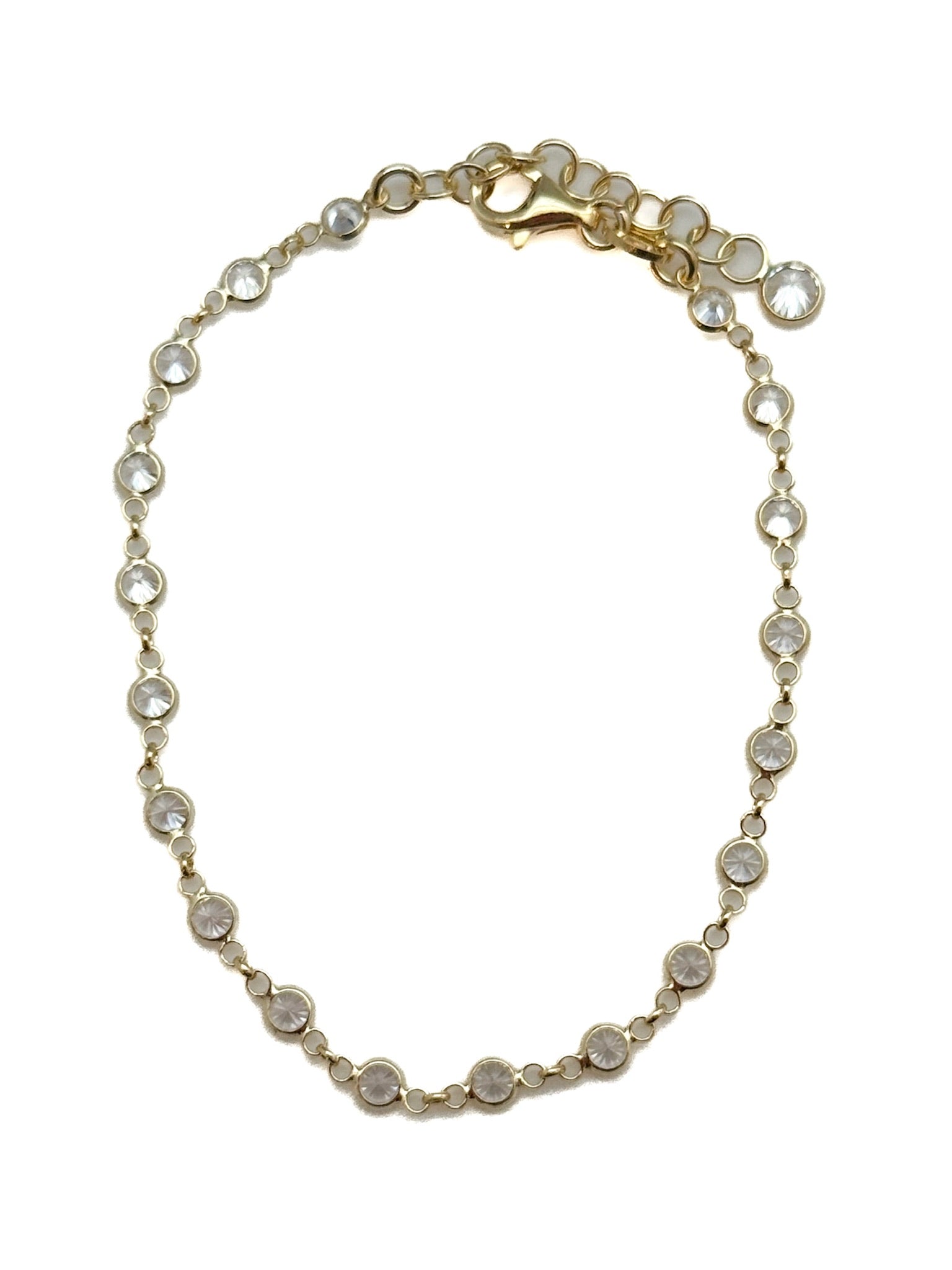 Gold bracelet with small stones on a white background