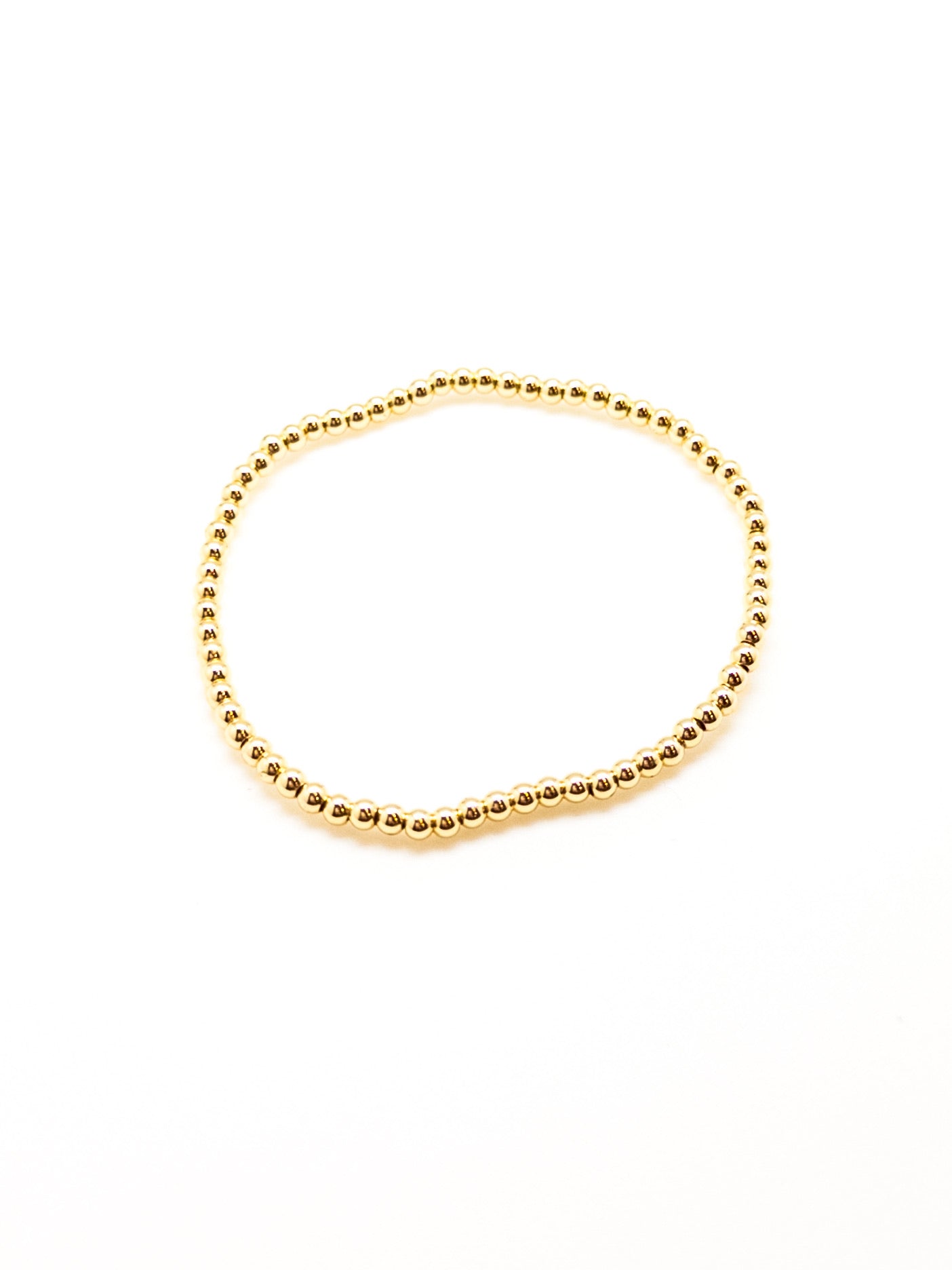 A gold-filled bracelet with a sleek, beaded design, displayed against a white background.