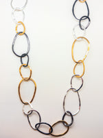 Long 45-inch mixed-metal link necklace featuring organic gold, silver, and black sculpted links.