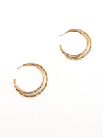 Gold hoop earrings on a white background