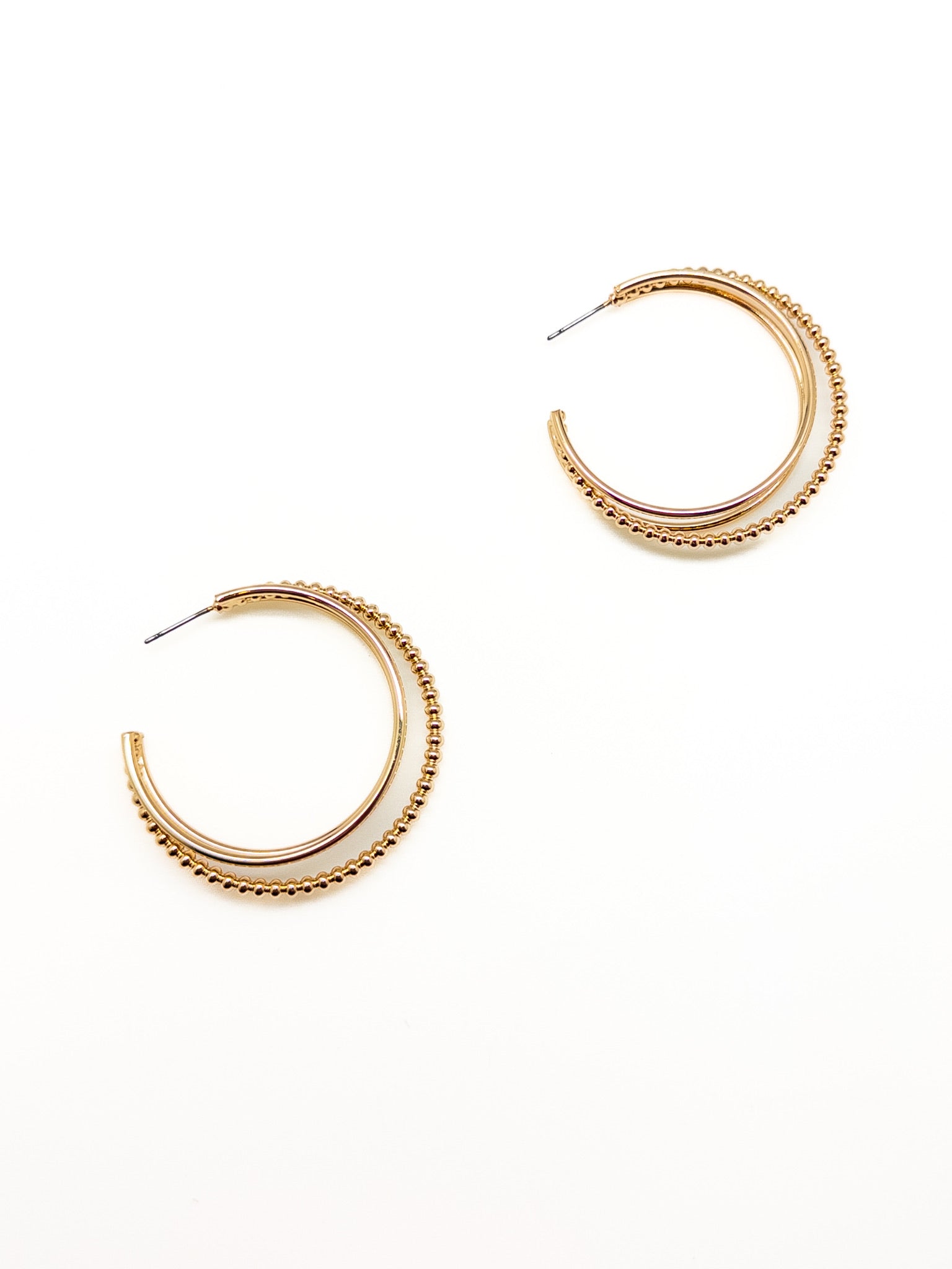 Gold hoop earrings on a white background