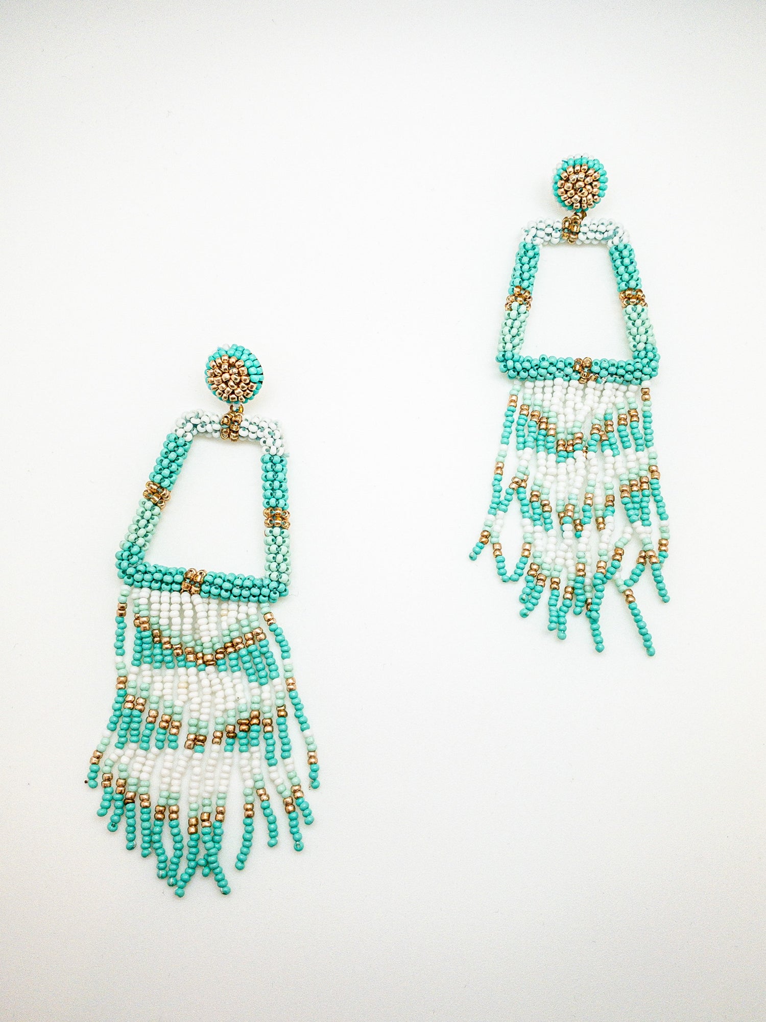 Teal Geometric shaped earrings on a white background 