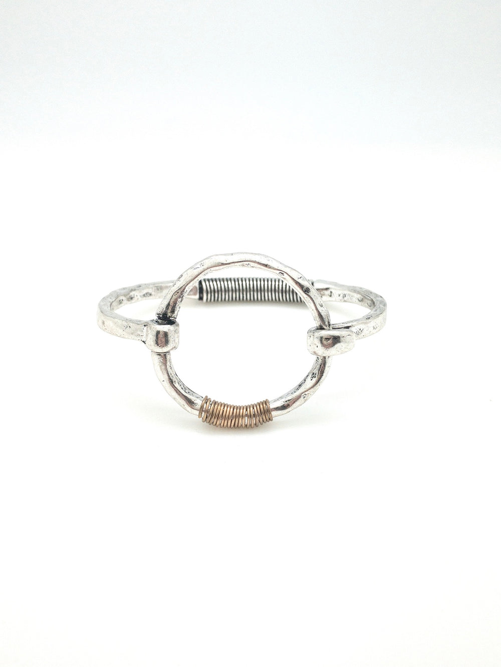 Silver cuff with a circle in center. gold wire wrapping.