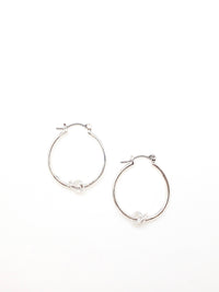 Silver Kelly hoop earrings with a knot detail in the bottom center of earring