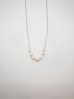 Gold Luna Necklace with delicate freshwater pearl accents at Ardor Boutique.