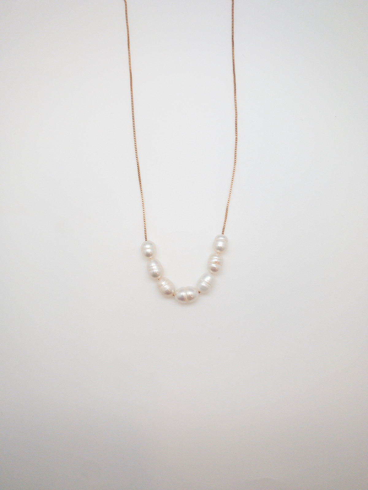 Gold Luna Necklace with delicate freshwater pearl accents at Ardor Boutique.