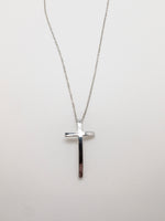 Silver-plated curved cross necklace with a delicate silver chain and slender cross pendant at Ardor Boutique.